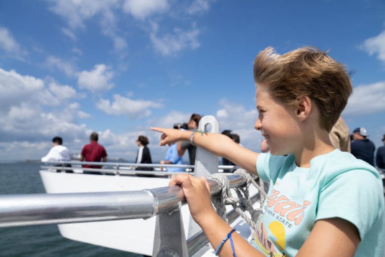 Passengers on the deck of a harbor cruise boat