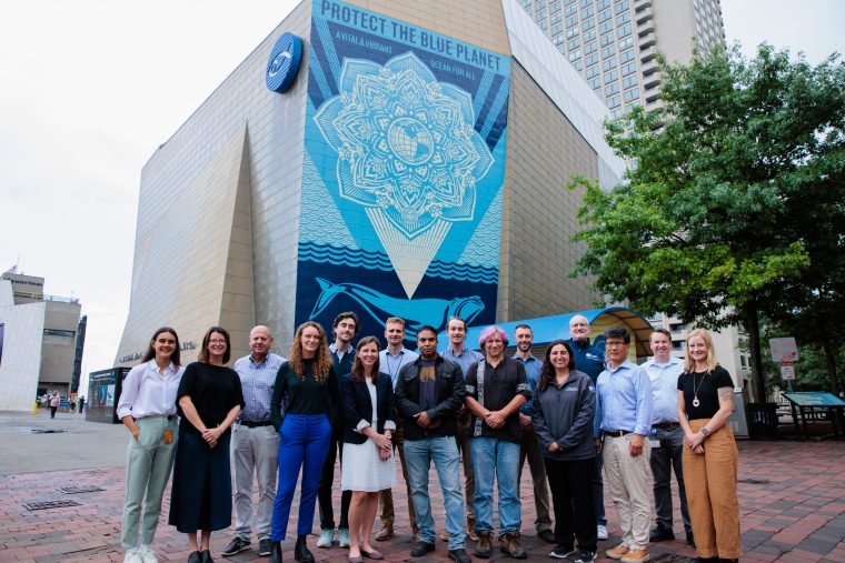 Group of adults standing outside the aquarium 