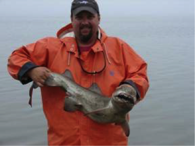 Man holding a small shark