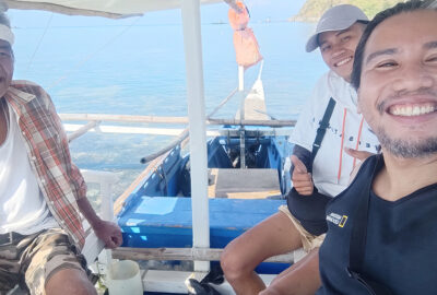 MCAF Project Leader Clint Gallaron in a boat with two other people, smiling at the camera