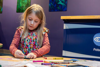 A young visitor participates in an activity
