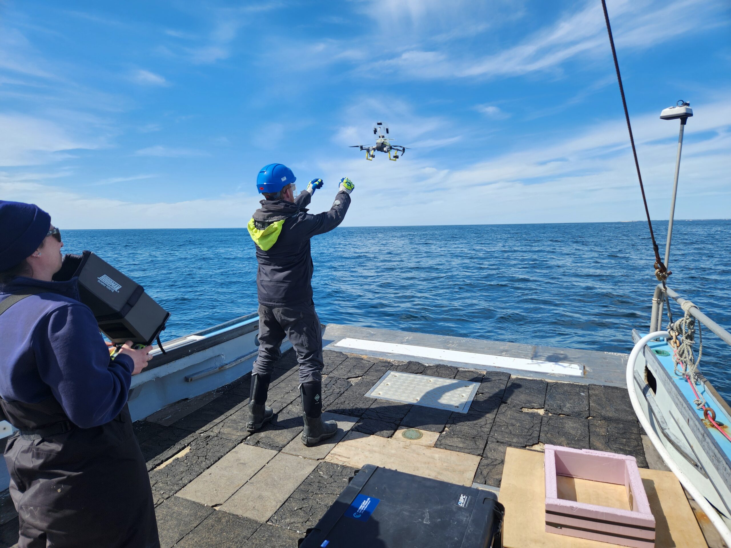Scientists using a drone to collect blow samples