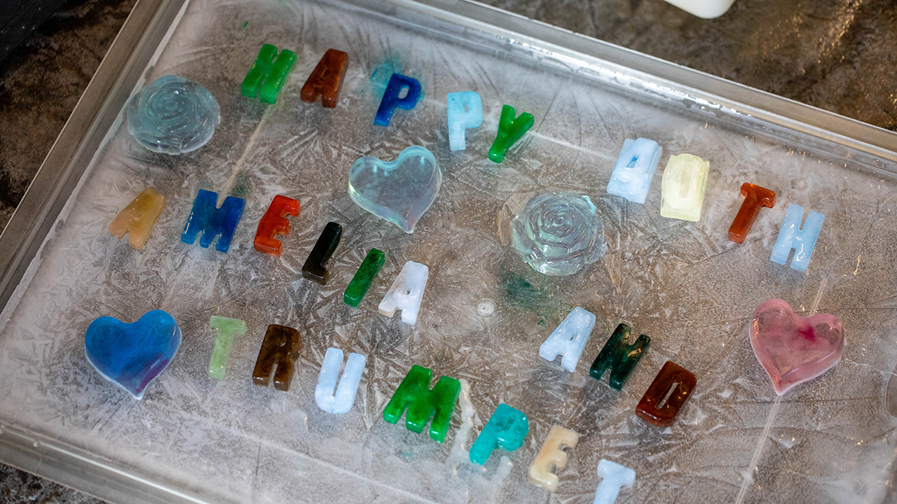 Colorful letters on an icy tray spelling 