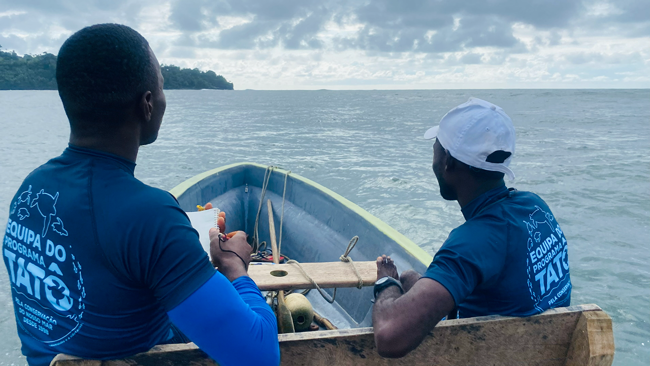 Two people on a boat looking at a cloudy ocean horizon. Transcribed Text: 
