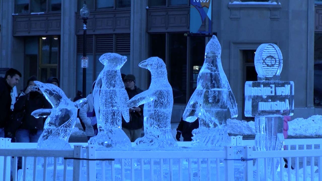 An ice sculpture depicting a playful group of penguins